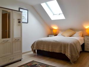 a bedroom with a bed and a skylight at Lloch Lo in Cilybebyll