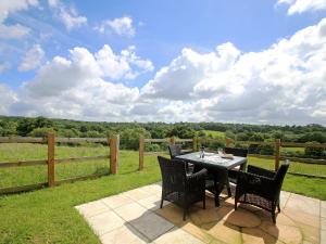 a patio with a table and chairs and a fence at Cherry Pip in Uckfield +3 photos