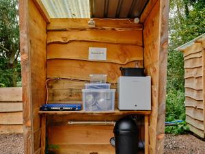 a wooden out house with a shelf in it at Clover - Ukc4940 in West Anstey