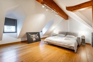 a bedroom with a large bed in a attic at Beautiful Design 2 BR Loft in Mertert