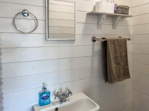 a bathroom with a sink and a mirror at Castle Lodge - Uk50987 in Sheriff Hutton