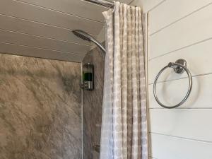 a shower with a shower curtain in a bathroom at Castle Lodge - Uk50987 in Sheriff Hutton +4 photos