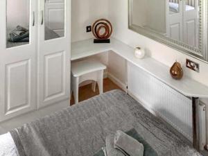 a bedroom with a bed and a table and a mirror at Aspen Lodge - Uk51190 in Morpeth