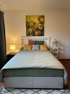 a bedroom with a bed with a painting on the wall at Ferienappartement Dümmerling in Lembruch in Lembruch