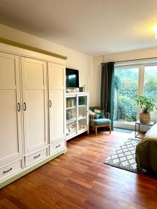 a bedroom with white cabinets and a large window at Ferienappartement Dümmerling in Lembruch in Lembruch