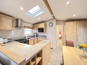 a kitchen with wooden cabinets and a skylight at Glenmoore 23 in St. Andrews