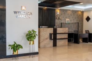 a lobby of a restaurant with plants in the foreground at Wyndham Garden Quito in Quito
