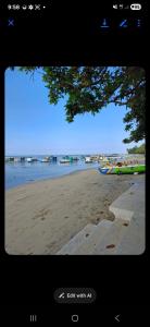 a television screen showing a beach with a view at ShaChi Beach House in Lian