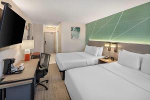a hotel room with two beds and a desk at Comfort Inn in Halifax