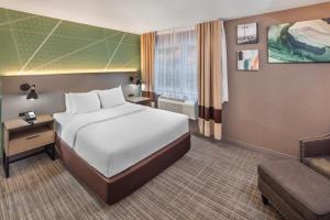 a hotel room with a bed and a couch at Comfort Inn in Halifax +48 photos