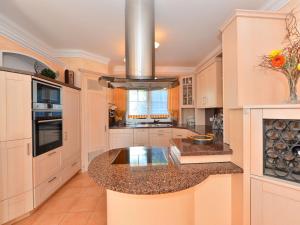 a large kitchen with white cabinets and a large island at Apartment near the river in Deggendorf Bavaria in Deggendorf