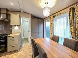 a kitchen with a dining room table and a window at Abington 14 in St. Andrews