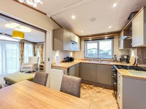 a kitchen with a table and chairs in a room at Abington 14 in St. Andrews