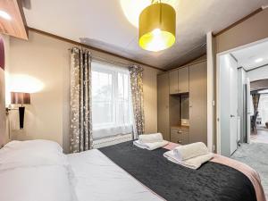 a bedroom with two beds and a window at Abington 14 in St. Andrews