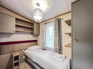 a small room with two beds and a window at Abington 14 in St. Andrews +3 photos