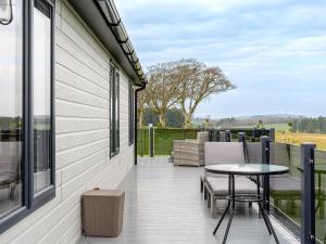 a patio with a table and chairs on a balcony at Lyndale 18 in St. Andrews