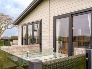 a patio with a glass table on a house at Lyndale 18 in St. Andrews