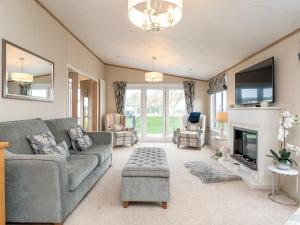 a living room with a couch and a fireplace at Lyndale 18 in St. Andrews