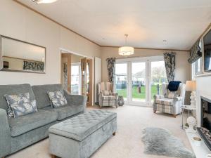 a living room with a couch and two chairs at Lyndale 18 in St. Andrews