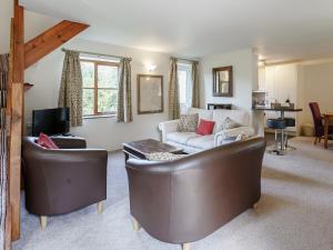 a living room with two chairs and a couch at Honeysuckle - Uk35244 in Llanfyrnach