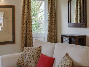 a living room with a white couch and a window at Honeysuckle - Uk35244 in Llanfyrnach