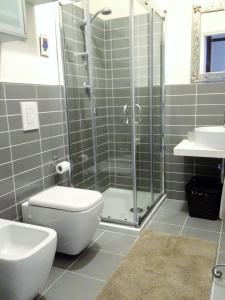 a bathroom with a shower and a toilet and a sink at Apartment With Garden in Lucca