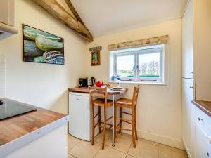 a kitchen with a small table and a window at Giddy Cottage - Ukc6127 in Eastdean