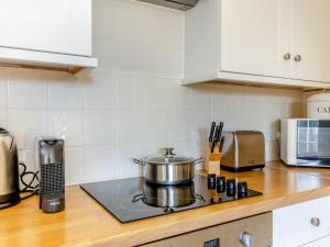 a kitchen counter with a pot on a stove at Hop Cottage - Ukc6134 in Eastdean +12 photos