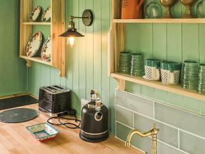 a kitchen counter with a tea kettle and a toaster at Dorset Alpaca Shepherd's Hut in Dorchester