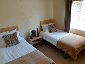 a bedroom with two beds and a window at Serenity Lodge-Uk3456 in Felton +5 photos