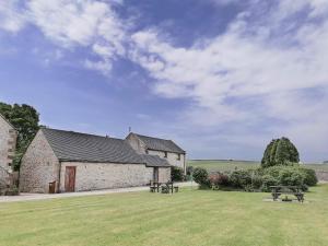 a stone building with a picnic table in a field at Milking Parlour - Uk4017 in Hartington +2 photos