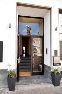 an open door to a building with a statue on it at Vinotel Dirmstein in Dirmstein