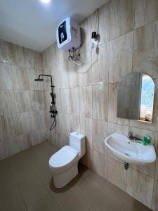 a bathroom with a toilet and a sink at Naima 3 in Panjadakan