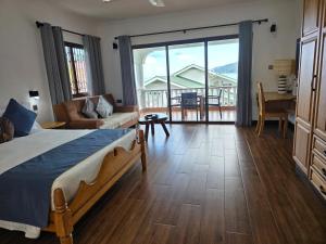 a bedroom with a bed and a living room at Drake Seaside Studio Apartments in Bel Ombre +71 photos