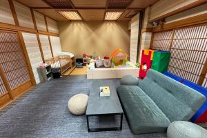 a living room with a couch and a table at Assobo 南紀白浜 in Asso