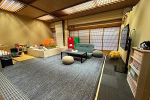 a living room with a table and a chair at Assobo 南紀白浜 in Asso