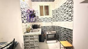 a small kitchen with a sink and a stove at Joy Homes in Cairo +11 photos