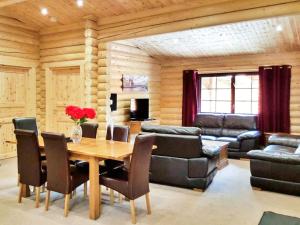 a dining room with a table and chairs and a couch at Hadrians Lodge - Uk3478 in West Thirston