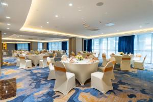 a conference room with tables and chairs in a room at DoubleTree by Hilton Dubai Port Saeed in Dubai