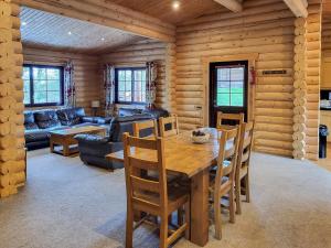 a dining room with a wooden table and chairs at Tweed Log Cabin-Uk3479 in West Thirston