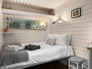 a small bed in a room with a mirror at The Shepherds Hut - Uk50986 in Sheriff Hutton +2 photos