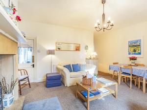 a living room with a couch and a table at Juliet Cottage in Alnwick