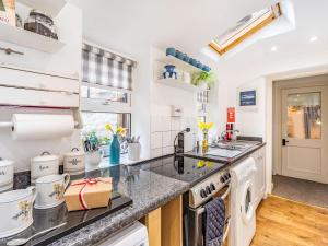 a kitchen with white appliances and a counter top at Juliet Cottage in Alnwick +8 photos