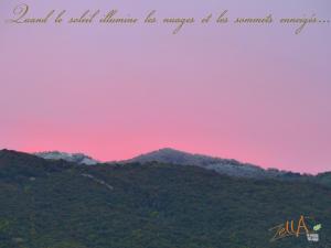 a pink and purple sky with mountains in the background at Maison d'Hôtes Zella in Bains de Guitera