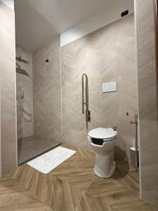 a bathroom with a shower and a toilet in it at INCLUSIVeLOFT in Legnano