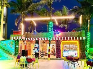 a restaurant with tables and chairs in front of a building at Hotel Sapphire International in Puri
