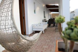 a hanging hammock in a room with a living room at SunΚissed Suite - Pollonia Milos in Pollonia
