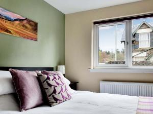 a bedroom with a bed and a window at Oakbank Cottage - Uk7574 in Pitlochry