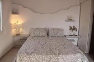 a bedroom with a bed and two night stands at SunΚissed Suite - Pollonia Milos in Pollonia +19 photos