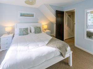 a bedroom with a large white bed with two lamps at Number Three - Ukc4965 in Tawstock